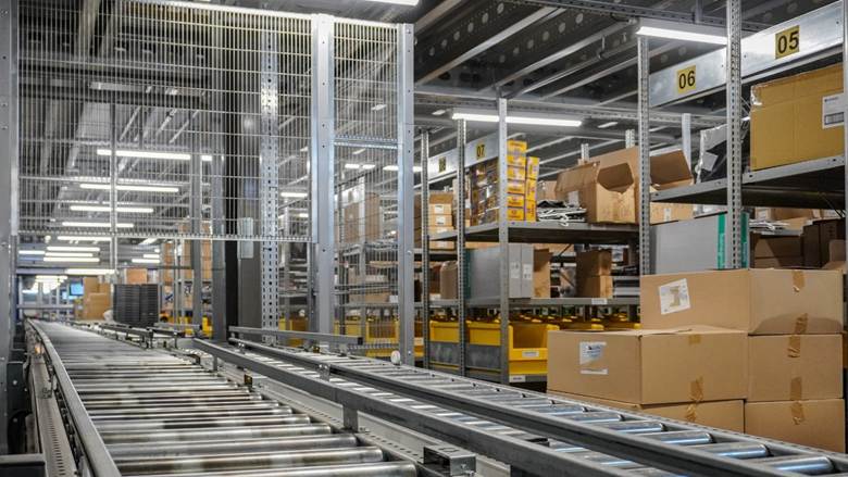 The image depicts an organized, industrial warehouse shelving system with rows of boxes and pallets, suggesting a highly structured and efficient storage or distribution area.